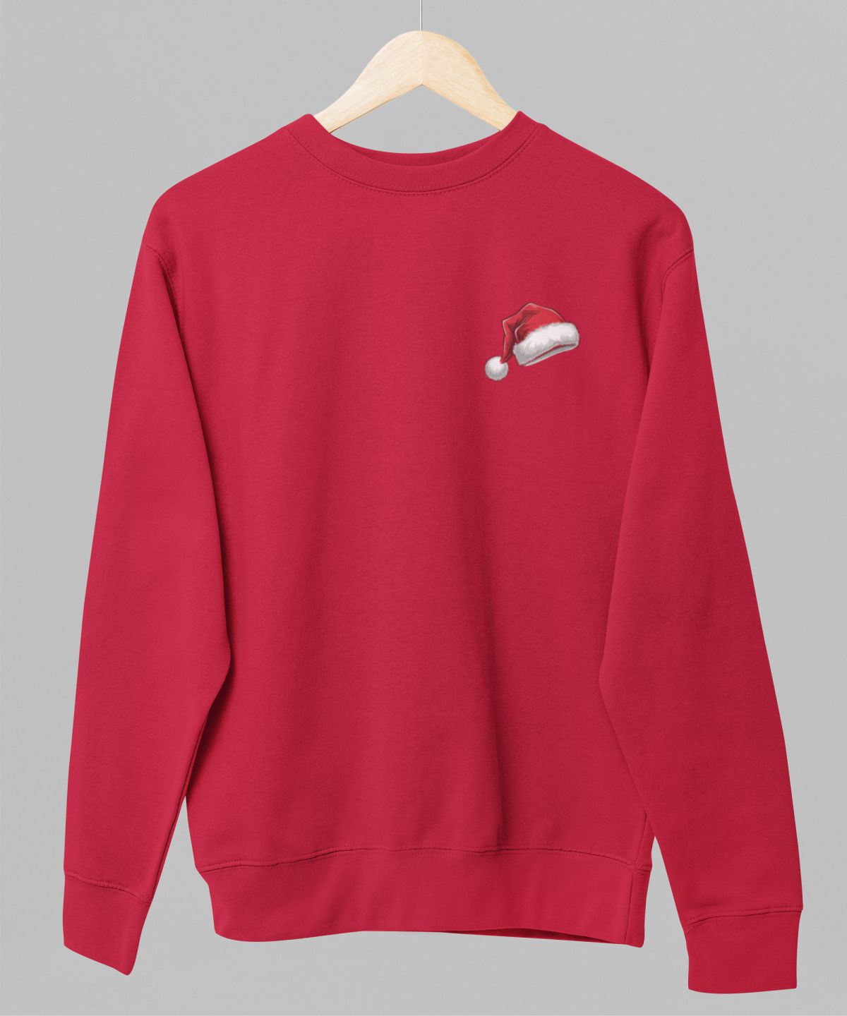 Sarkans UNISEX džemperis bez kapuces "Ziemassvētku cepurīt"